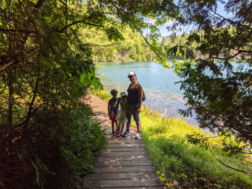 Picture of Mel, writer behind Modest Millionaires, with her kids on a hike.